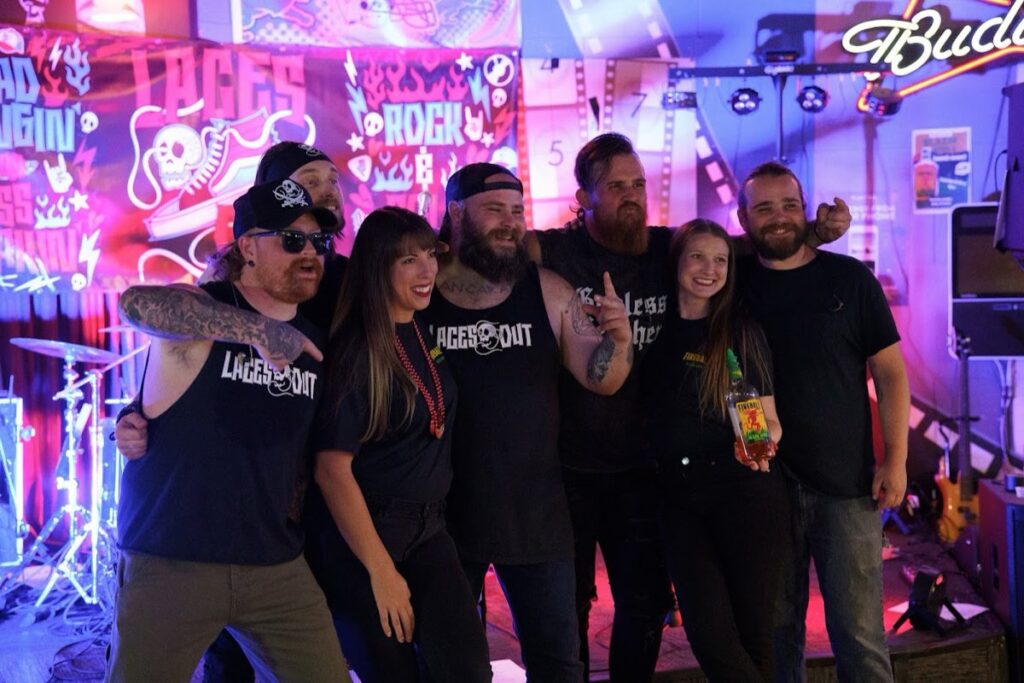 The Laces Out band posing with fans after a show