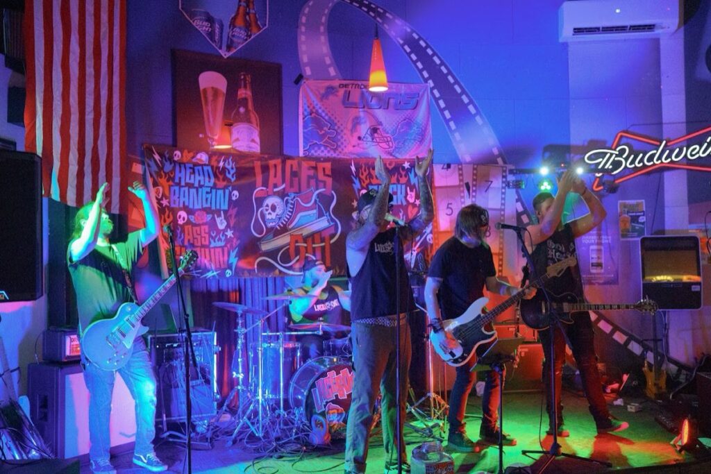 Laces Out performing live on stage, full band under red and blue lights